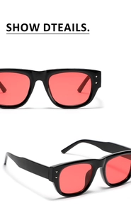 Detail of square sunglasses with black frame, red lenses and silver metal rivets