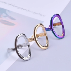 Detailed macro view of three adjustable geometric oval rings in gold, silver, and multicolor