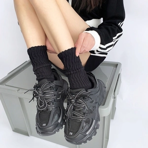 Classic black layered chunky sneakers with matching long socks and size 38 toe detail
