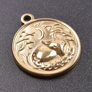Close-up of golden stainless steel round pendant featuring a cat and moon engraved pattern