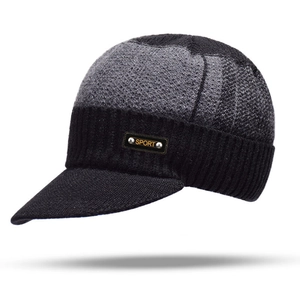 Detail view of the gray and black knitted visor beanie with a sport metal rivet patch