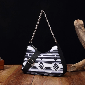 Close-up of bohemian shoulder bag with black and white geometric patterns and chain