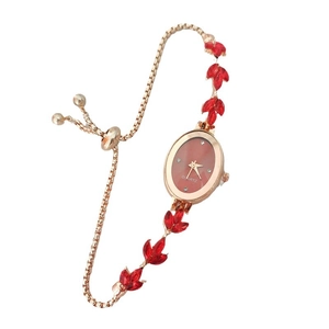 Rose gold wheat spike watch with red leaf gemstones and an oval quartz dial on white background