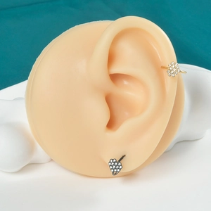 Detailed view of black and gold butterfly ear cuffs with crystals on a model ear