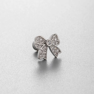 Sparkling zircon bow stud earring in silver titanium steel on a gray background