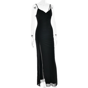 Detail view of the elegant ruching and thigh-high side slit on this slim fit black maxi dress