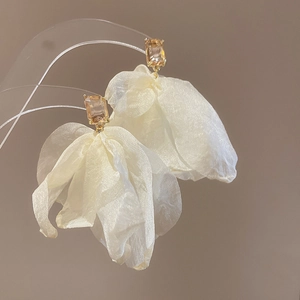 Elegant white silk flower earrings with orange gemstone accent and silver pin closure