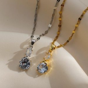 Detailed view of cherry pendant necklaces with sparkling crystals in gold and silver finish