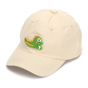 Detail shot of a beige kids baseball cap with a 3D cartoon green dragon silicone patch