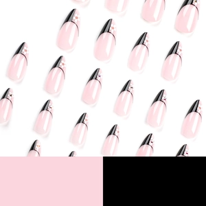 French almond press-on nails with black tip design, white flowers, and rhinestone accents