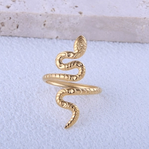 Macro detail of a gold snake-shaped stainless steel ring with an adjustable open design