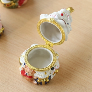 Christmas tree ceramic jewelry box with teddy bear decor and gold trim on wood surface