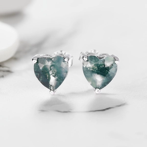 Macro view of S925 silver heart stud earrings with natural green moss agate stones