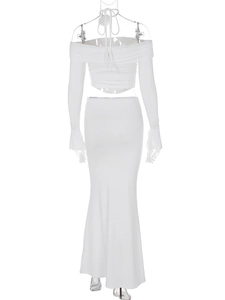Detail of white two-piece knit set featuring back view of crop top and floor-length skirt