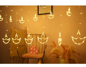 Detail of warm yellow LED Diya curtain lights for festive Diwali home decoration