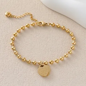 Elegant gold beaded bracelet featuring heart pendants with Eternal Love engraving