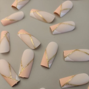 Long coffin press-on nails with pink, white, and gold glitter geometric matte design
