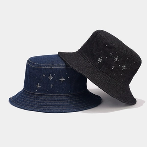 Detail of denim bucket hats in navy and black featuring rhinestone star patterns