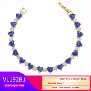 Detail of 18K gold plated heart bracelet with blue zircons and white crystals