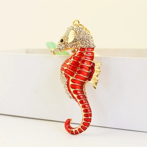 Sparkling seahorse keychain pendant with red enamel and crystals on gold plating