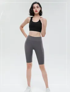 Detail of high-waist yoga shorts and U-neck sports bra on model for fitness workout