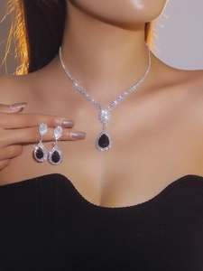Detail of luxury bridal jewelry set with black teardrop stones on a fashion model