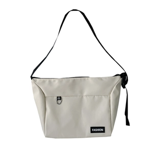 Minimalist off-white canvas crossbody messenger bag with black adjustable strap for daily use