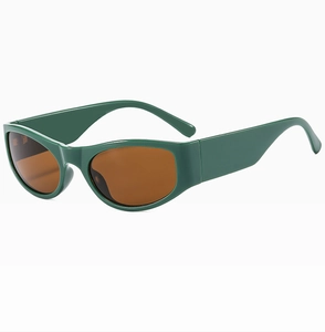 Detail of retro dark green oval sunglasses with wide temples and brown tinted lenses