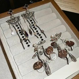 Elegant silver needle drop earrings with sparkling crystal flowers and tassels in dark style