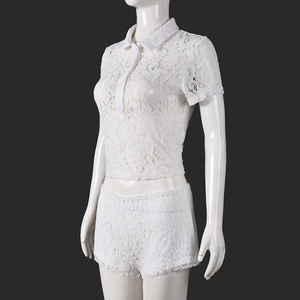 Detail view of white lace polo-neck crop top and matching shorts on a mannequin