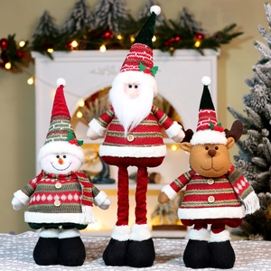 Three plush Christmas dolls featuring Santa, Snowman and Reindeer with festive decor
