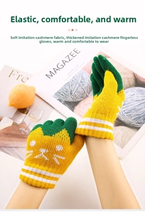 Detail of warm yellow-green knit gloves with cat embroidery and white striped wrist cuff