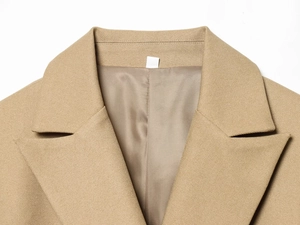 Detailed view of camel blazer notch lapel showing premium twill fabric texture and stitching
