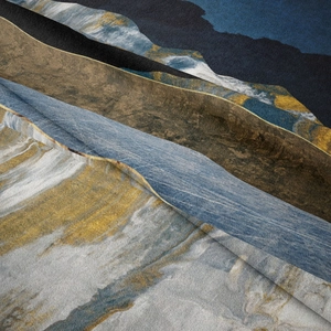 Macro shot of abstract mountain tapestry showing the soft texture and blue gold flowing pattern