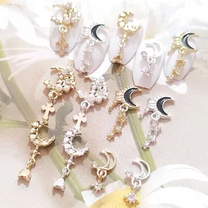 Golden moon and star alloy nail charms with black enamel and faux pearl accents