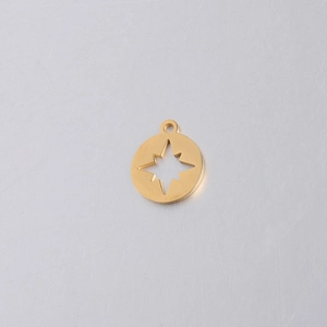 Macro view of gold stainless steel compass pendant with cut-out star detail