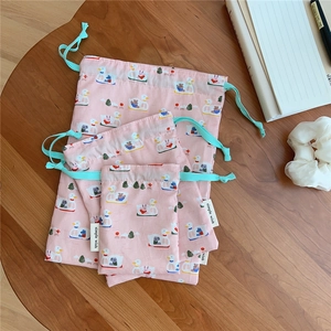Detailed set of three pink cotton drawstring bags with cute duck and boat illustrations