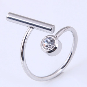 Detail of silver geometric ring featuring a horizontal metal bar and inset zircon stone