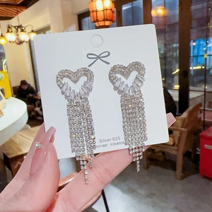 Macro view of long heart tassel earrings with sparkling zircons and S925 silver needles