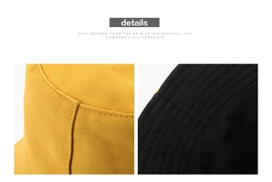 Detail of yellow and black cotton twill bucket hat with reinforced stitching seams