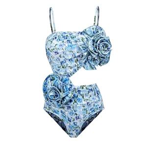 Macro detail of high-stretch floral swimsuit with 3D fabric flowers and cut-out waist
