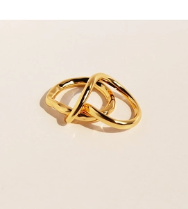 Macro shot of interlocking golden rings with unique molten texture and metallic luster