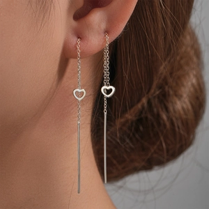 Close-up of S925 sterling silver long tassel heart threader earrings on model