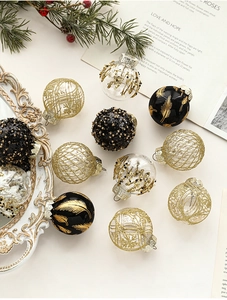 Detailed view of 5cm gold and black Christmas baubles with glitter and beads