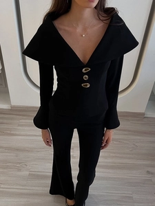 Detailed view of elegant off-shoulder top with metallic buttons and flared trousers set