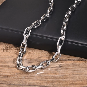 Silver rectangular link chain necklace displayed on a black leather jewelry box