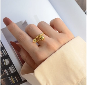 Detailed view of an 18K gold plated titanium steel ring with dual sphere minimalist design