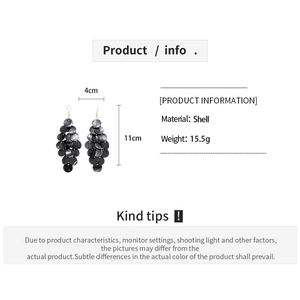 Detailed size view of long grey shell earrings with layered circular fringe design