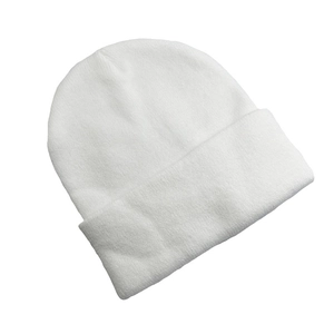 Detail showing the white knitted texture and double-layered folded cuff of the skull beanie