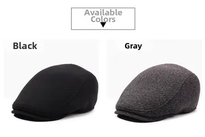 Detail view of winter beret hats in black and dark grey showing twill fabric texture